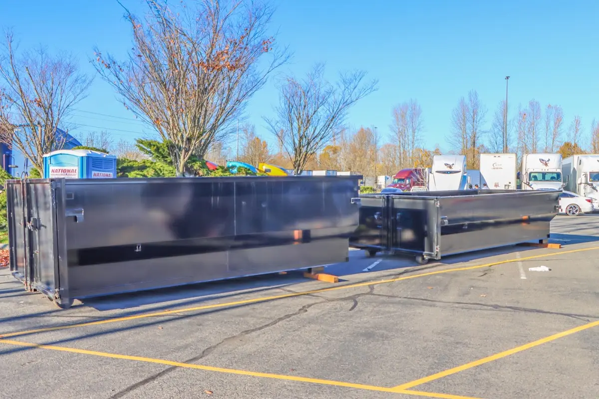 Professional dumpster rental service with roll-off container on residential driveway in Palatine